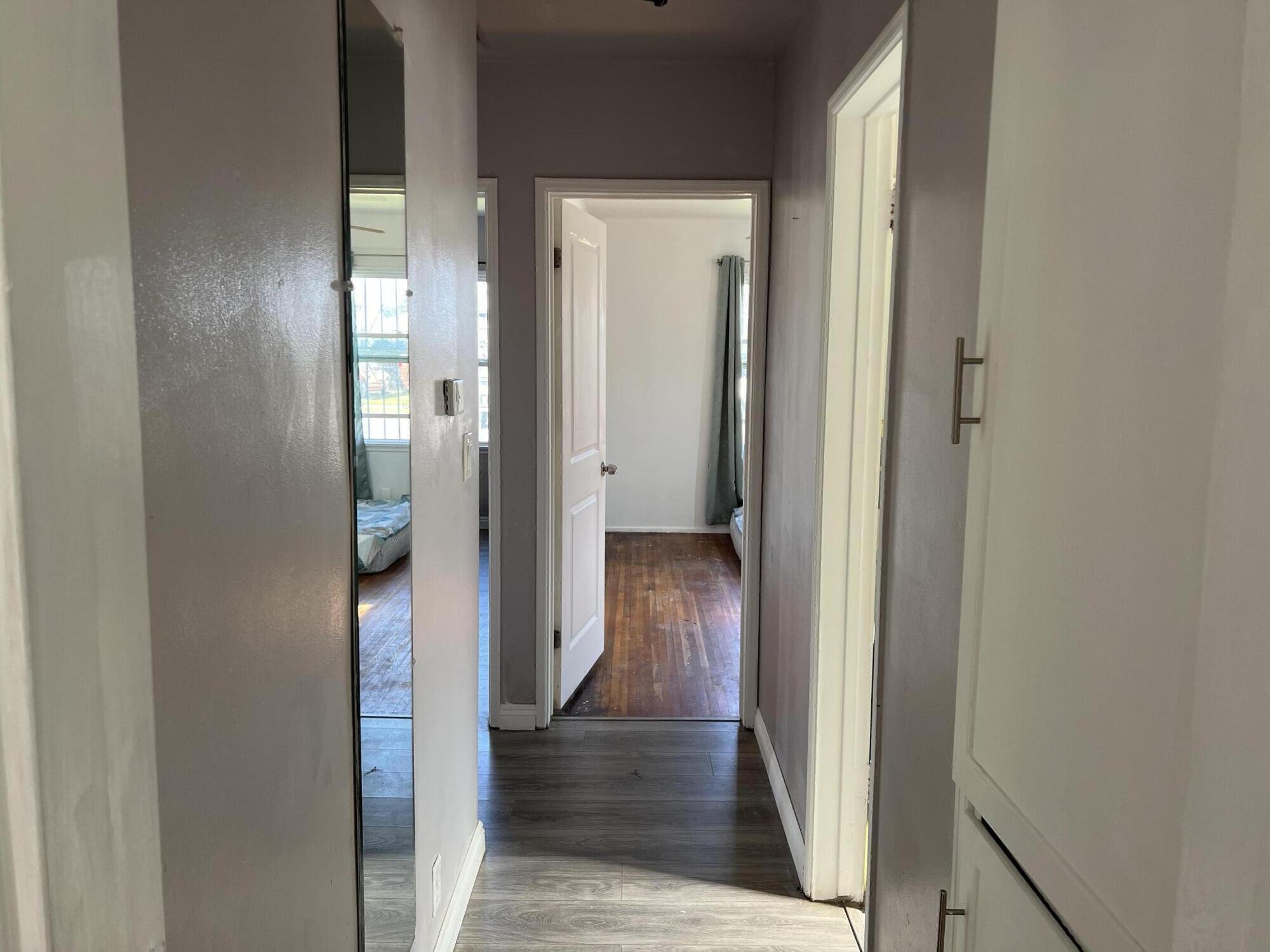4916 Brompton Avenue Bell, CA 90201 - Photo 28 of 50 a view of a hallway with wooden floor and a bathroom
