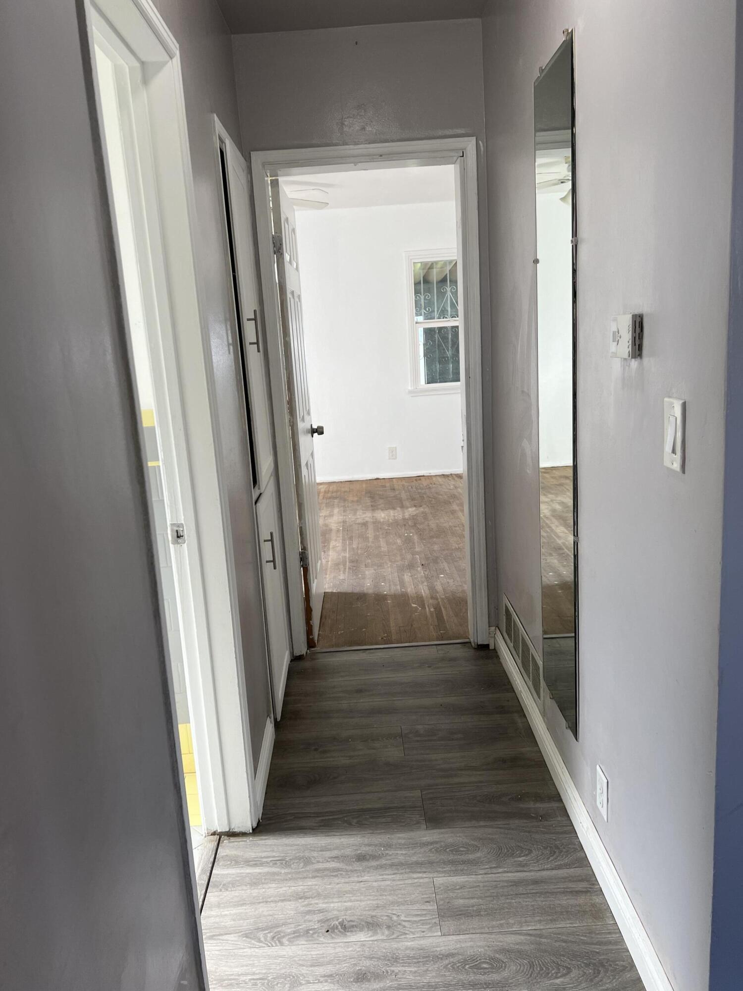 4916 Brompton Avenue Bell, CA 90201 - Photo 29 of 50 a view of a hallway with wooden floor and staircase
