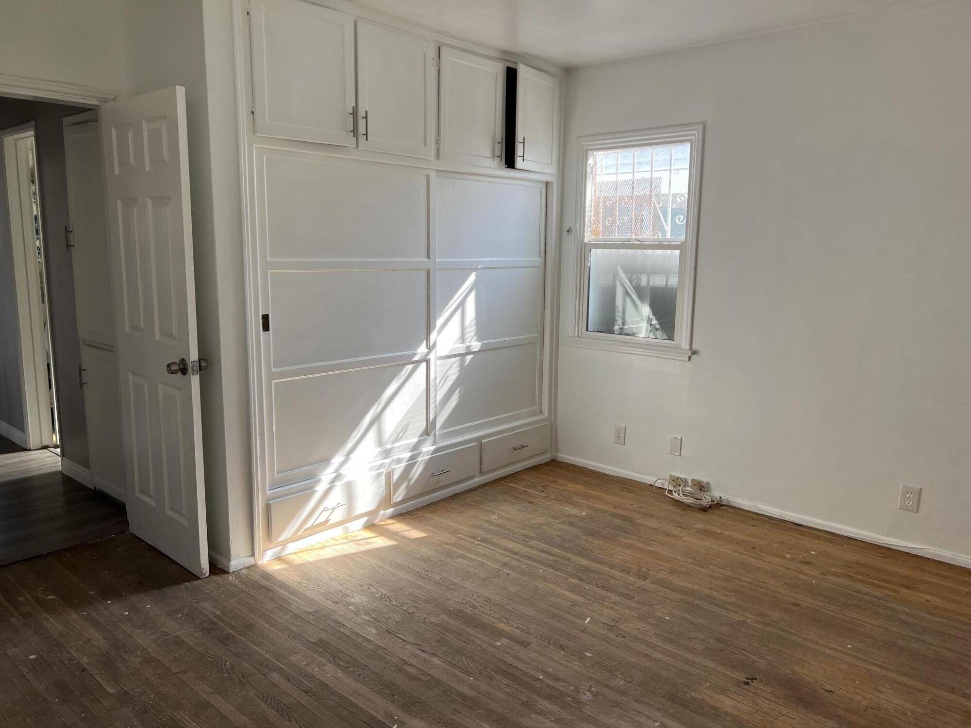 4916 Brompton Avenue Bell, CA 90201 - Photo 31 of 50 a view of an empty room with wooden floor and a window