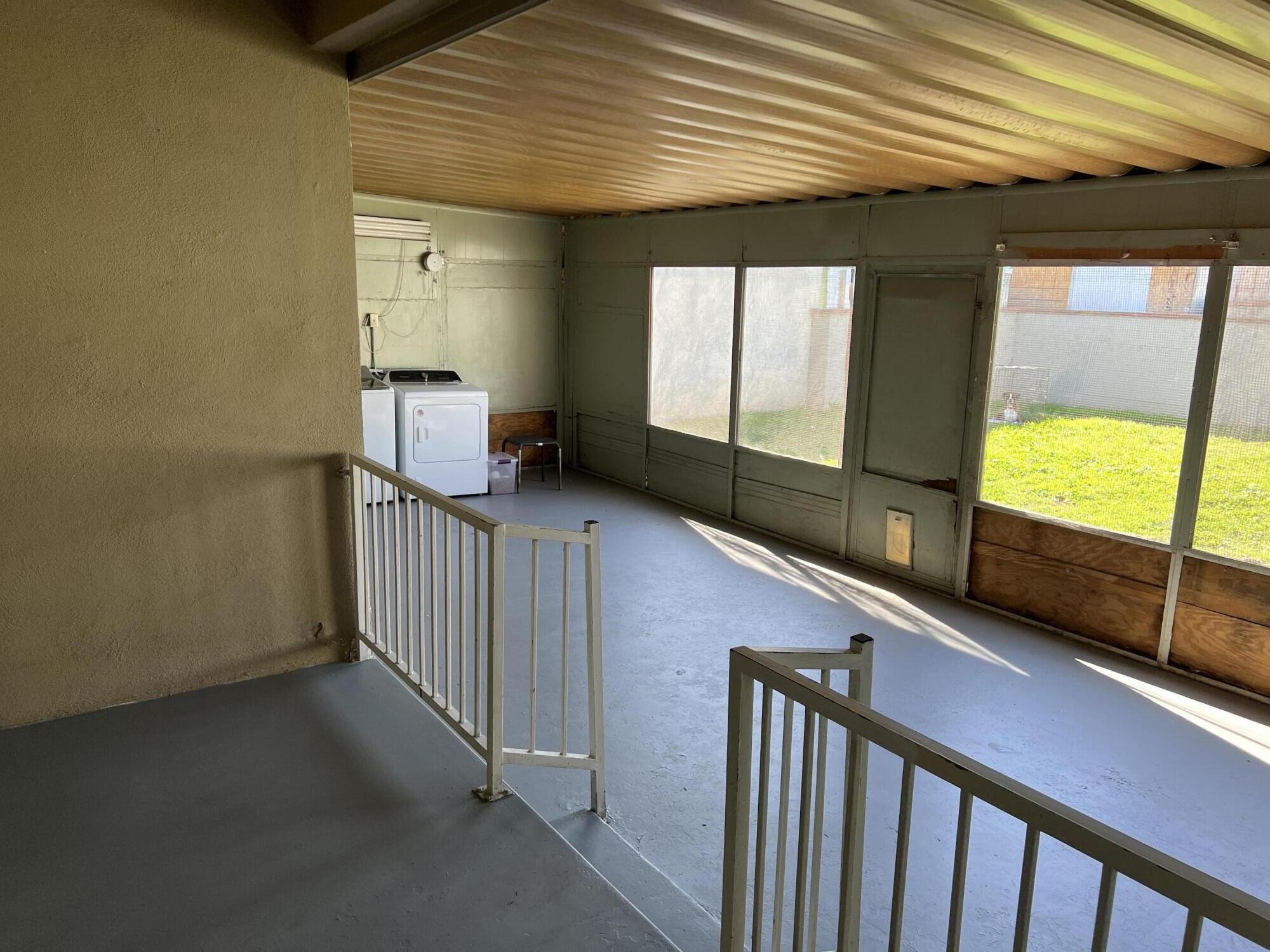 4916 Brompton Avenue Bell, CA 90201 - Photo 4 of 50 a view of a porch with wooden floor and stairs
