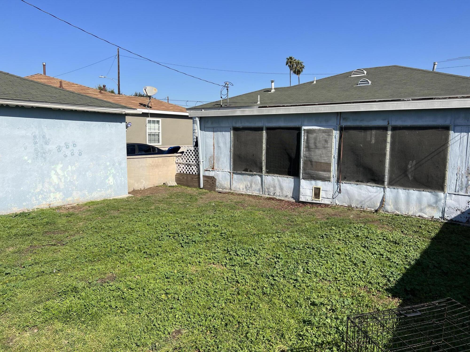 4916 Brompton Avenue Bell, CA 90201 - Photo 43 of 50 a front view of a house with a garden