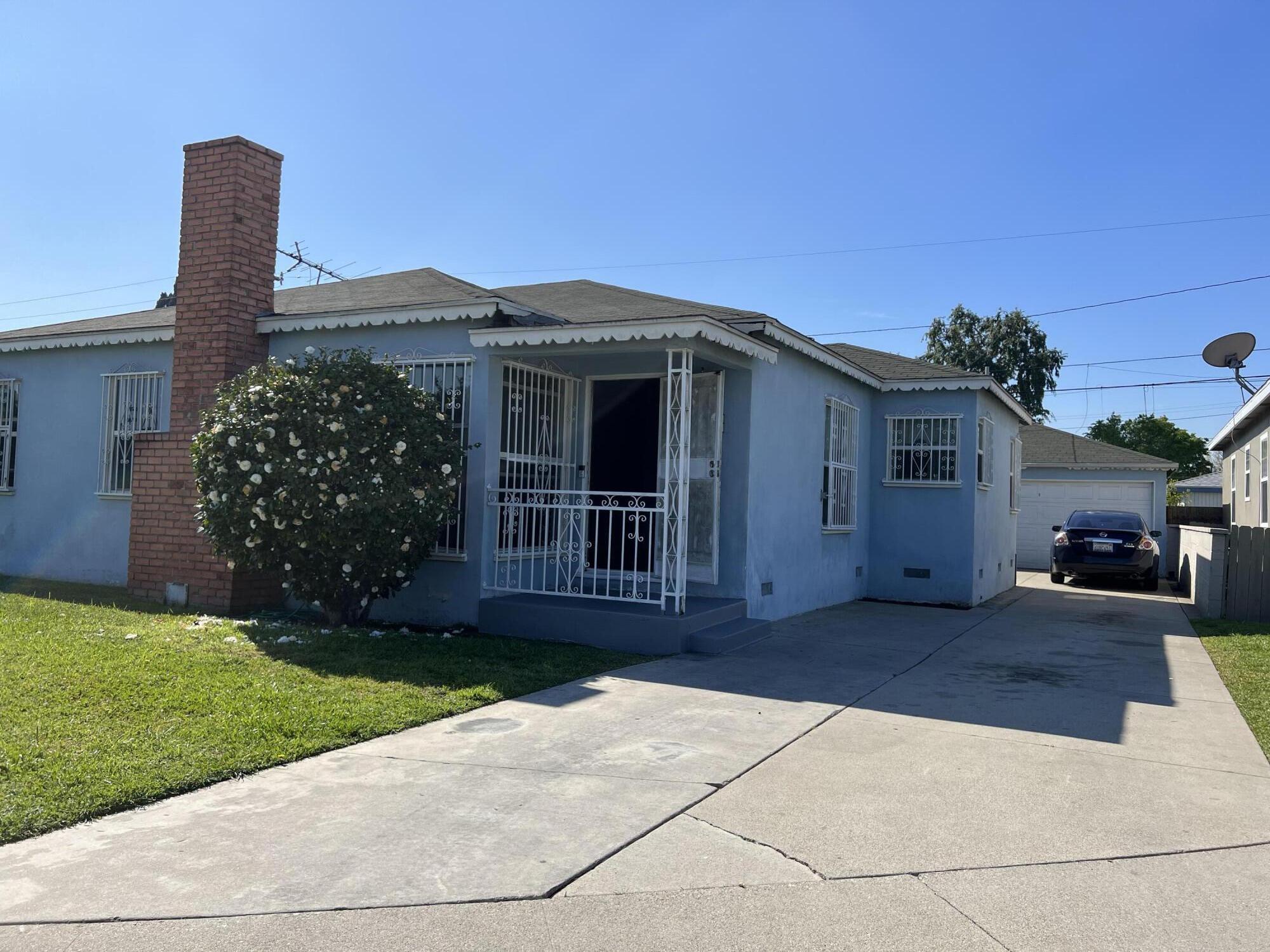 4916 Brompton Avenue Bell, CA 90201 - Photo 48 of 50 a front view of a house with garden