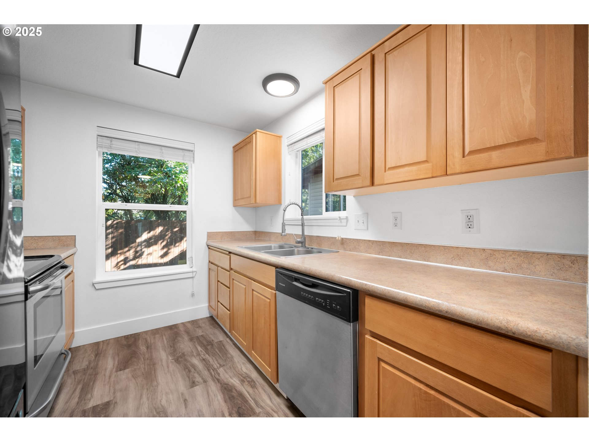 1407 Southwest 6th Avenue Battle Ground, WA 98604 - Photo 11 of 35 a kitchen with granite countertop a sink a window and cabinets