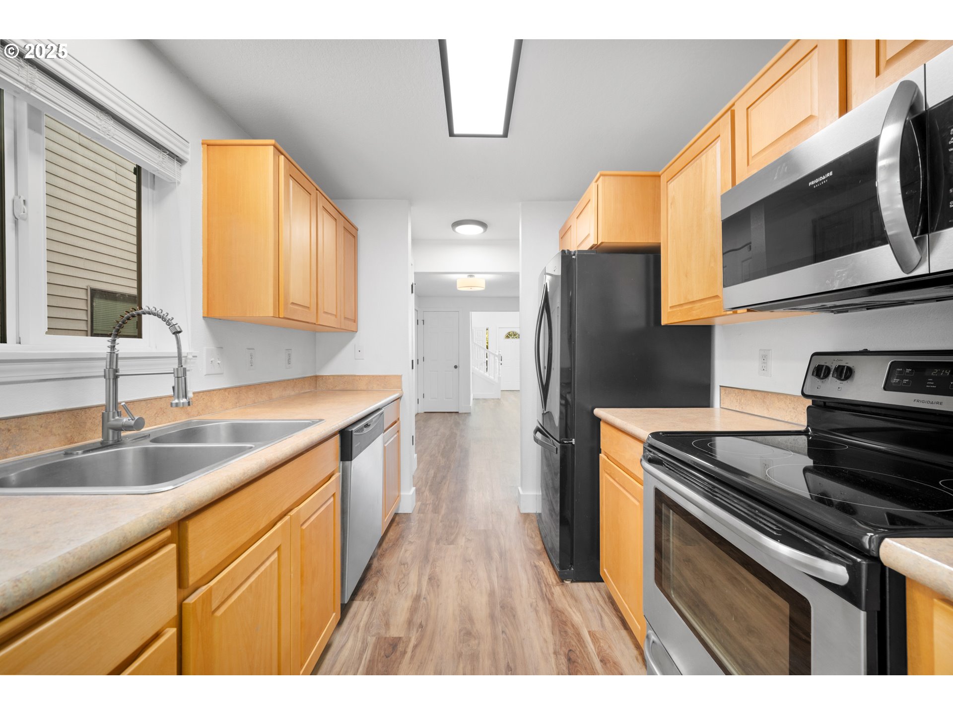 1407 Southwest 6th Avenue Battle Ground, WA 98604 - Photo 12 of 35 a kitchen with stainless steel appliances granite countertop a sink a stove and a refrigerator