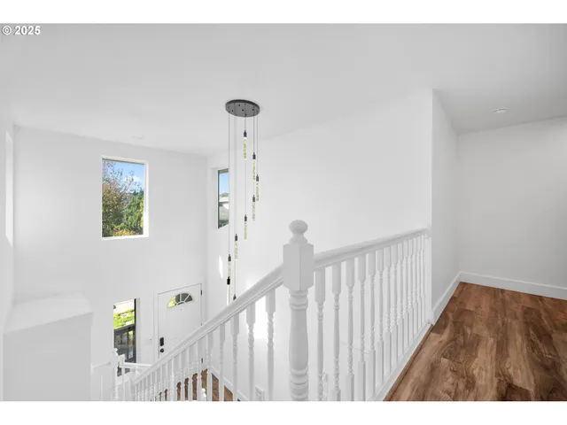 a view of a hallway and wooden floor