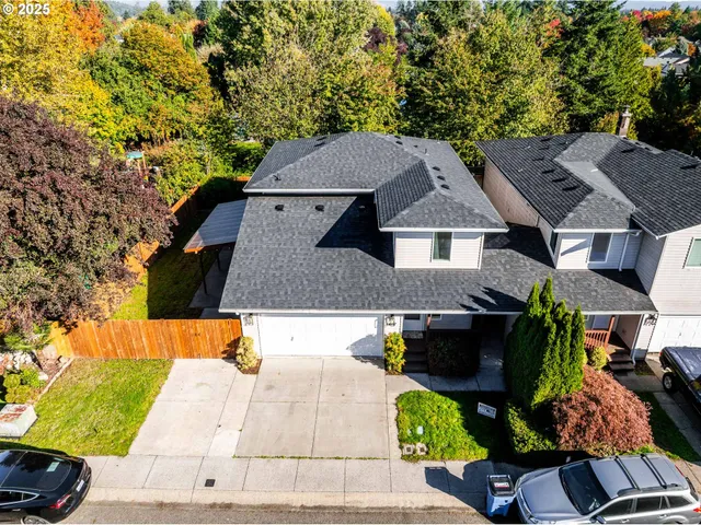 an aerial view of a house with a garden and sitting area