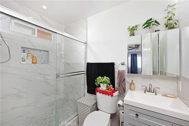 a bathroom with a sink mirror and toilet