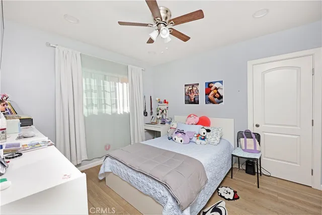 a bedroom with a bed and wooden floor