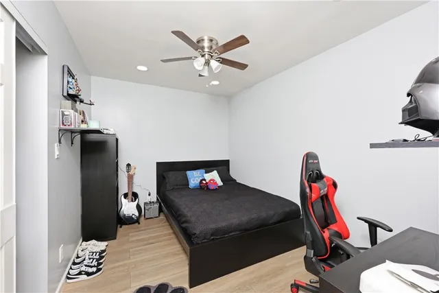 a living room with a bed furniture and a chandelier