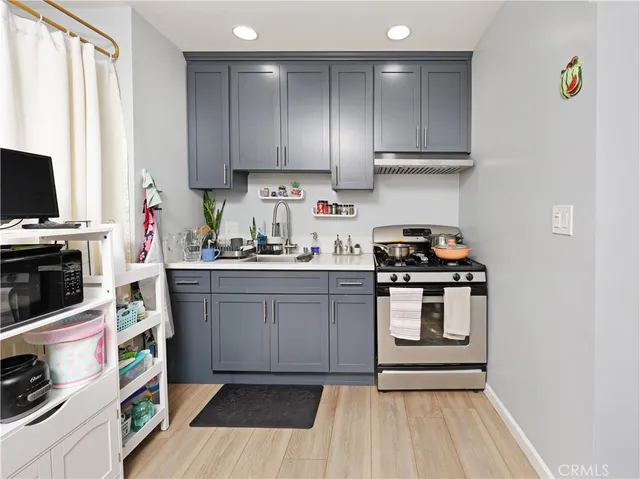 a kitchen with a sink stove and cabinets