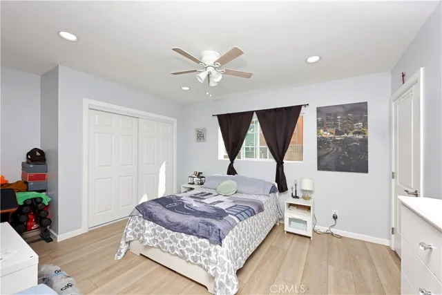 a bedroom with a large bed and a window