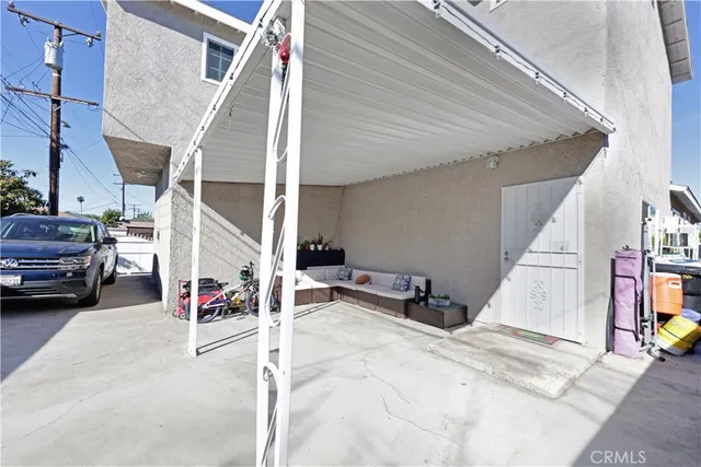 a living room with furniture and kitchen view