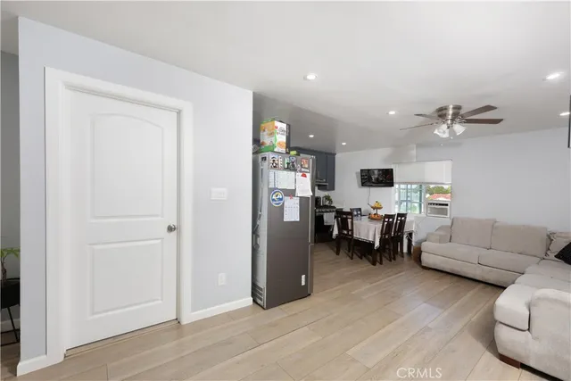 a living room with furniture and kitchen view