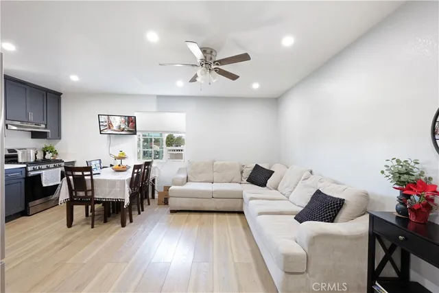 a kitchen with stainless steel appliances wooden floor and refrigerator
