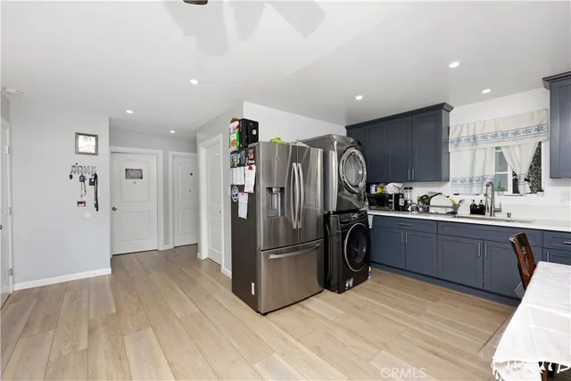 a bedroom with 2 bed and a chandelier