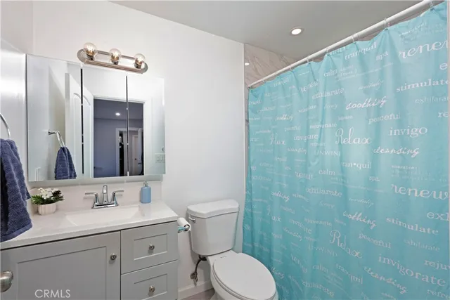 a view of a livingroom with wooden floor and furniture