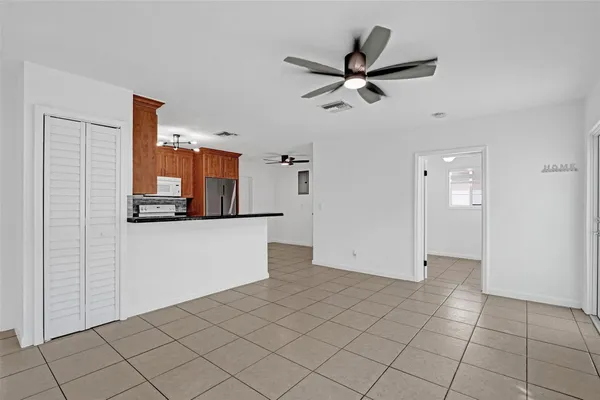 a kitchen with granite countertop a refrigerator stove top oven and sink