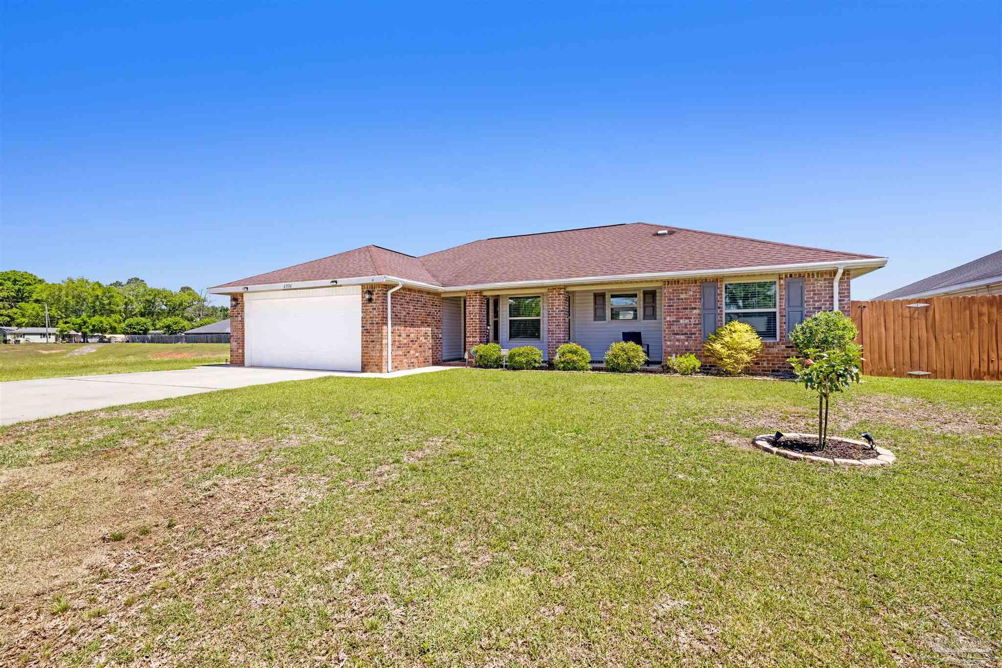 6336 Apple Ridge Circle Pensacola, FL 32526 - Photo 1 of 41 a front view of a house with a yard
