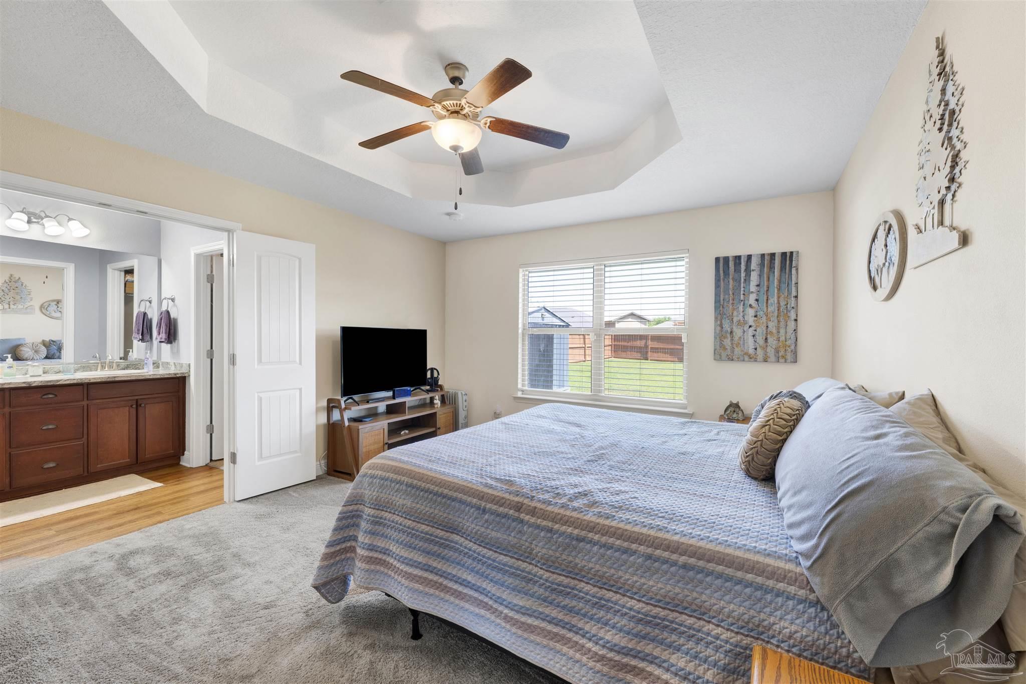 6336 Apple Ridge Circle Pensacola, FL 32526 - Photo 17 of 41 a bedroom with a bed and a large mirror with a flat tv screen