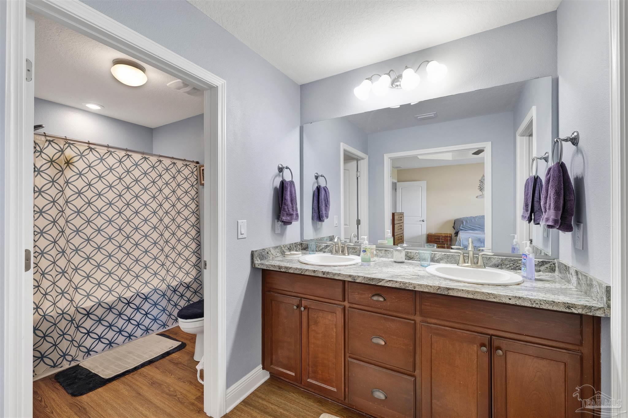6336 Apple Ridge Circle Pensacola, FL 32526 - Photo 19 of 41 a bathroom with a double vanity sink mirror and shower