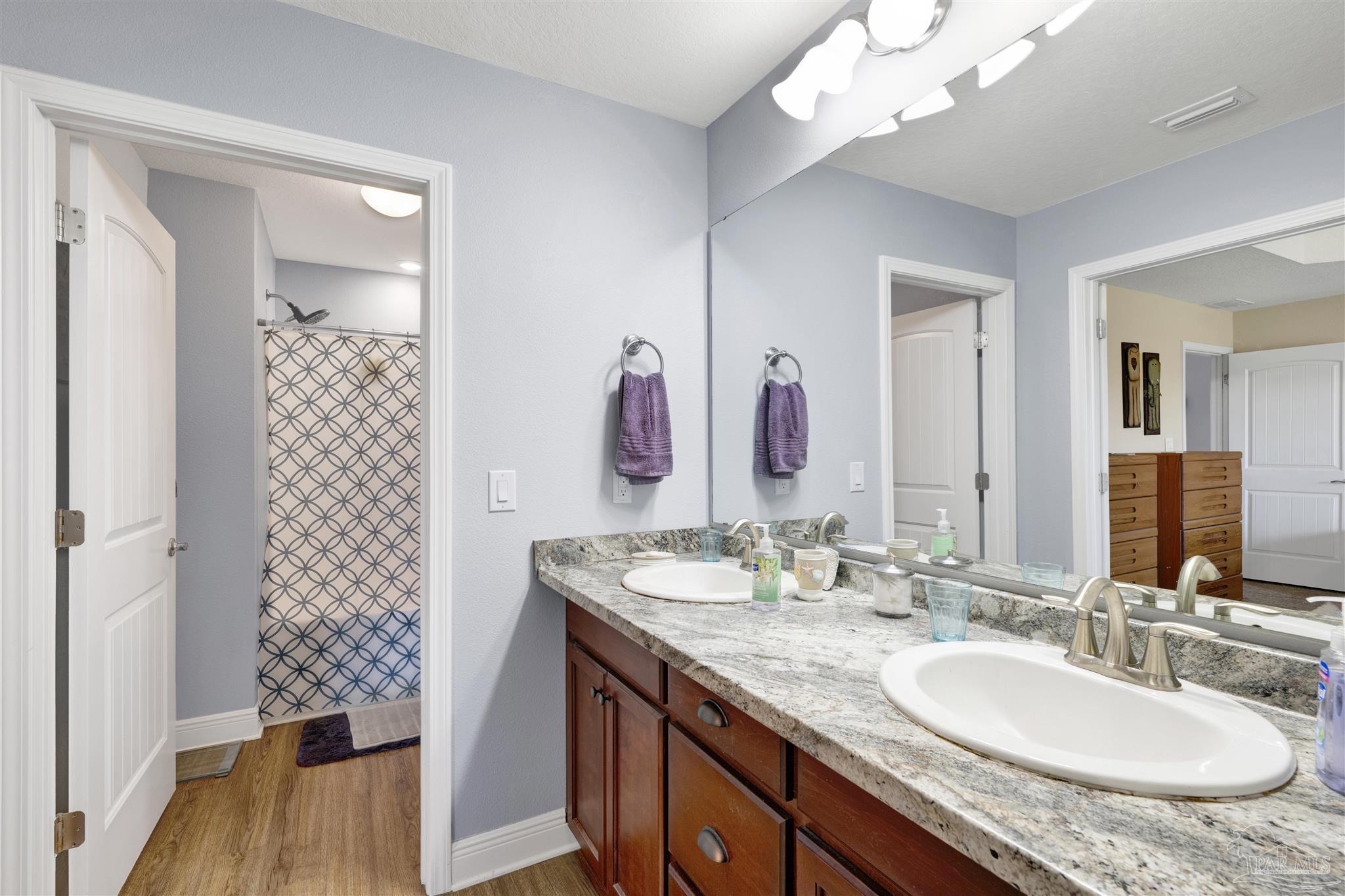6336 Apple Ridge Circle Pensacola, FL 32526 - Photo 20 of 41 a bathroom with a granite countertop sink a large mirror and a shower