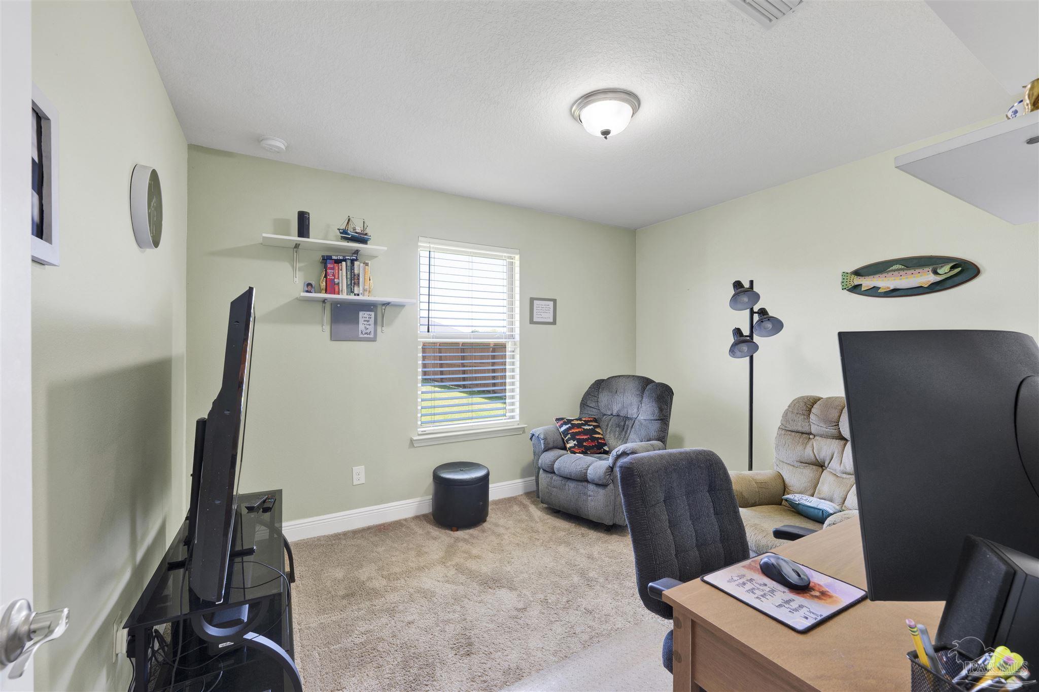 6336 Apple Ridge Circle Pensacola, FL 32526 - Photo 23 of 41 a living room with furniture and a flat screen tv