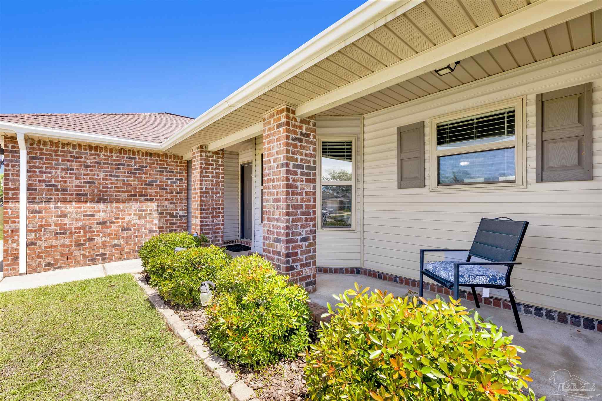 6336 Apple Ridge Circle Pensacola, FL 32526 - Photo 3 of 41 a front view of a house with a garden