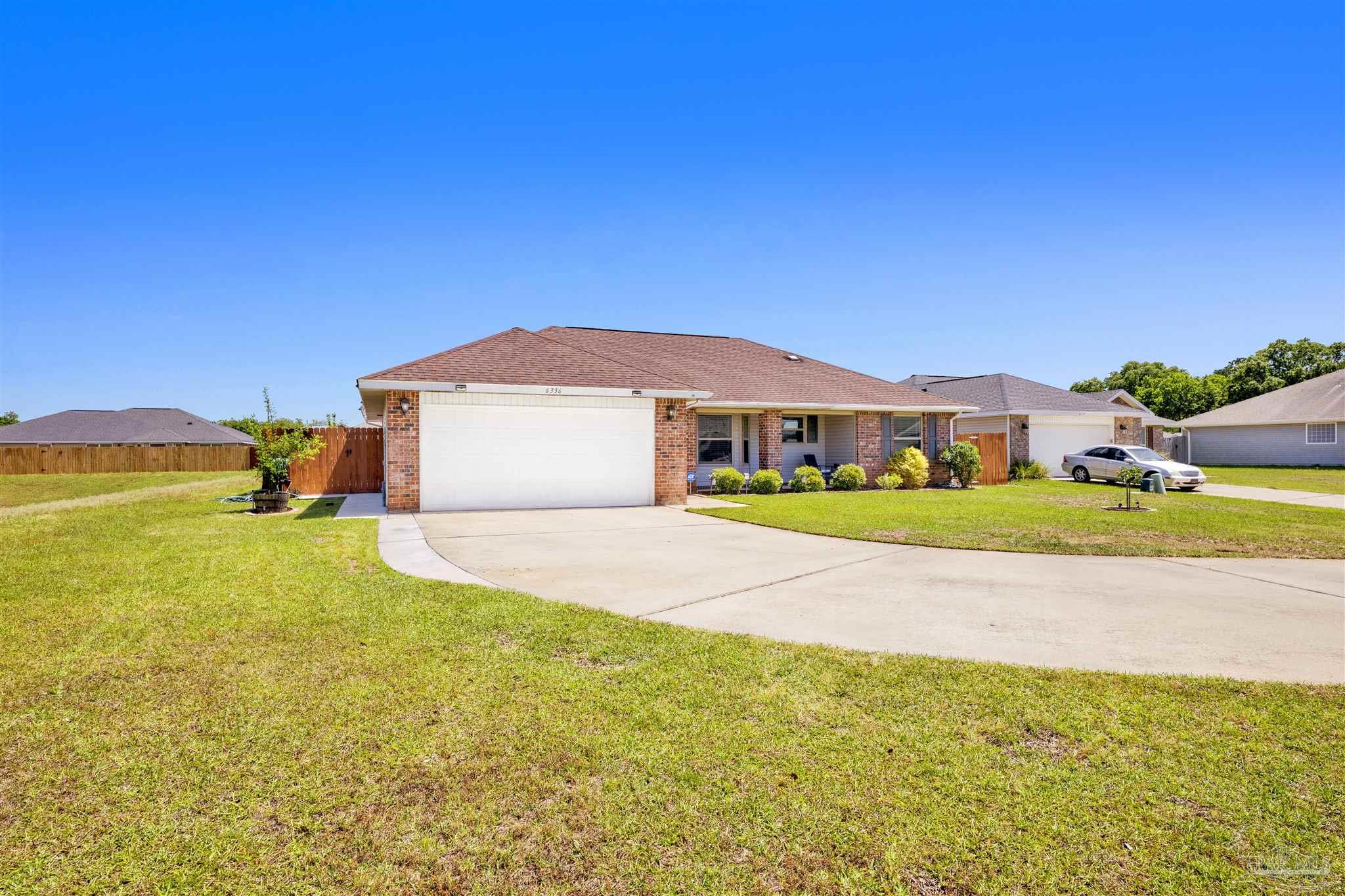 6336 Apple Ridge Circle Pensacola, FL 32526 - Photo 32 of 41 a front view of a house with a yard and garage