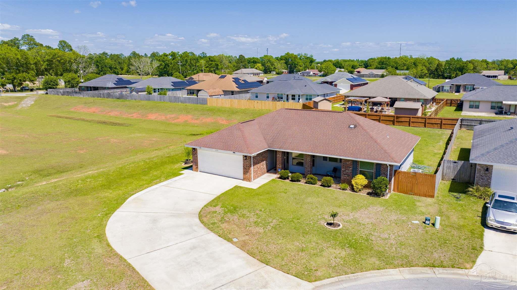6336 Apple Ridge Circle Pensacola, FL 32526 - Photo 37 of 41 a view of a swimming pool with outdoor seating and a garden