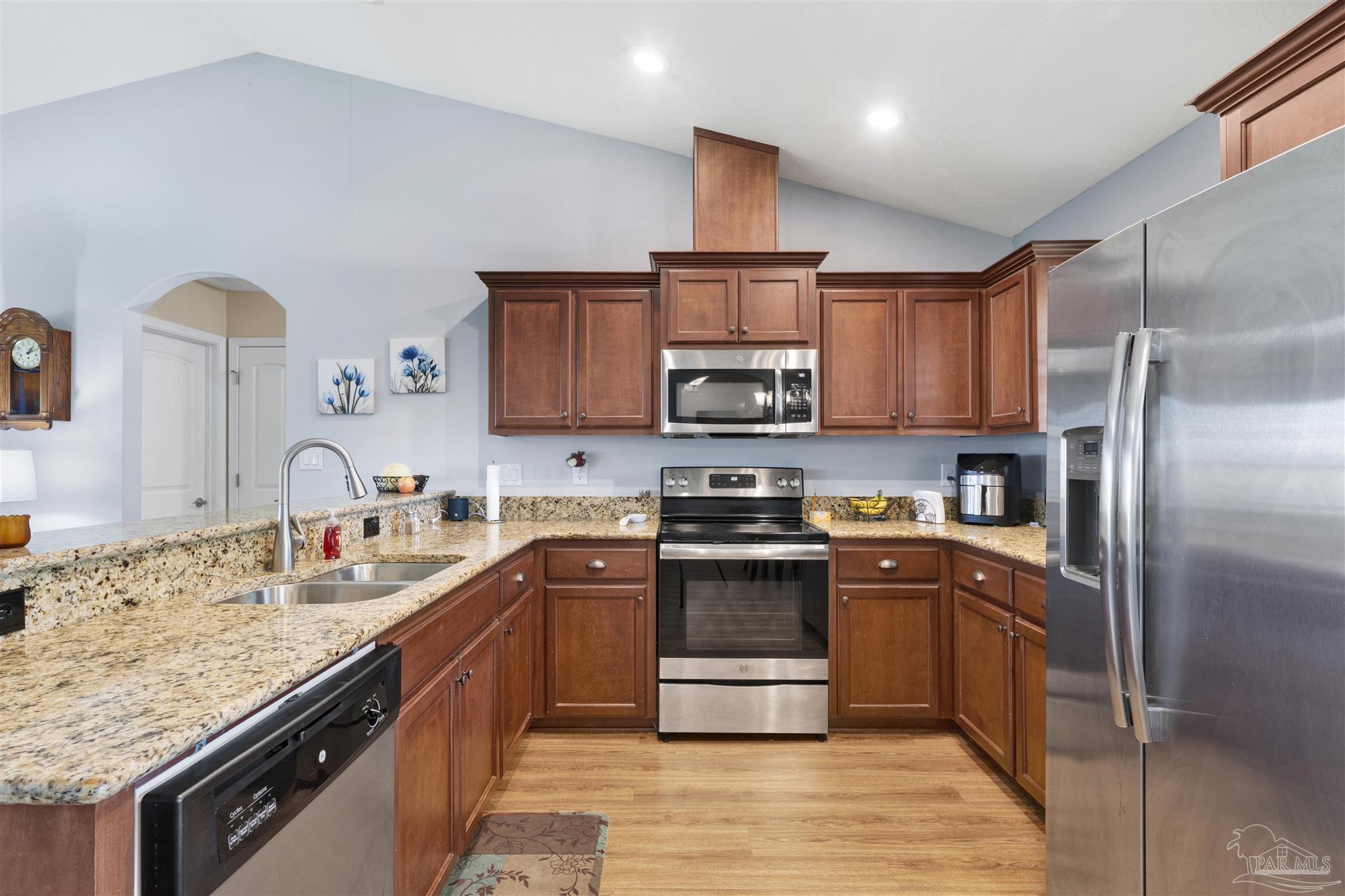 6336 Apple Ridge Circle Pensacola, FL 32526 - Photo 7 of 41 a kitchen with stainless steel appliances granite countertop a stove refrigerator sink and microwave