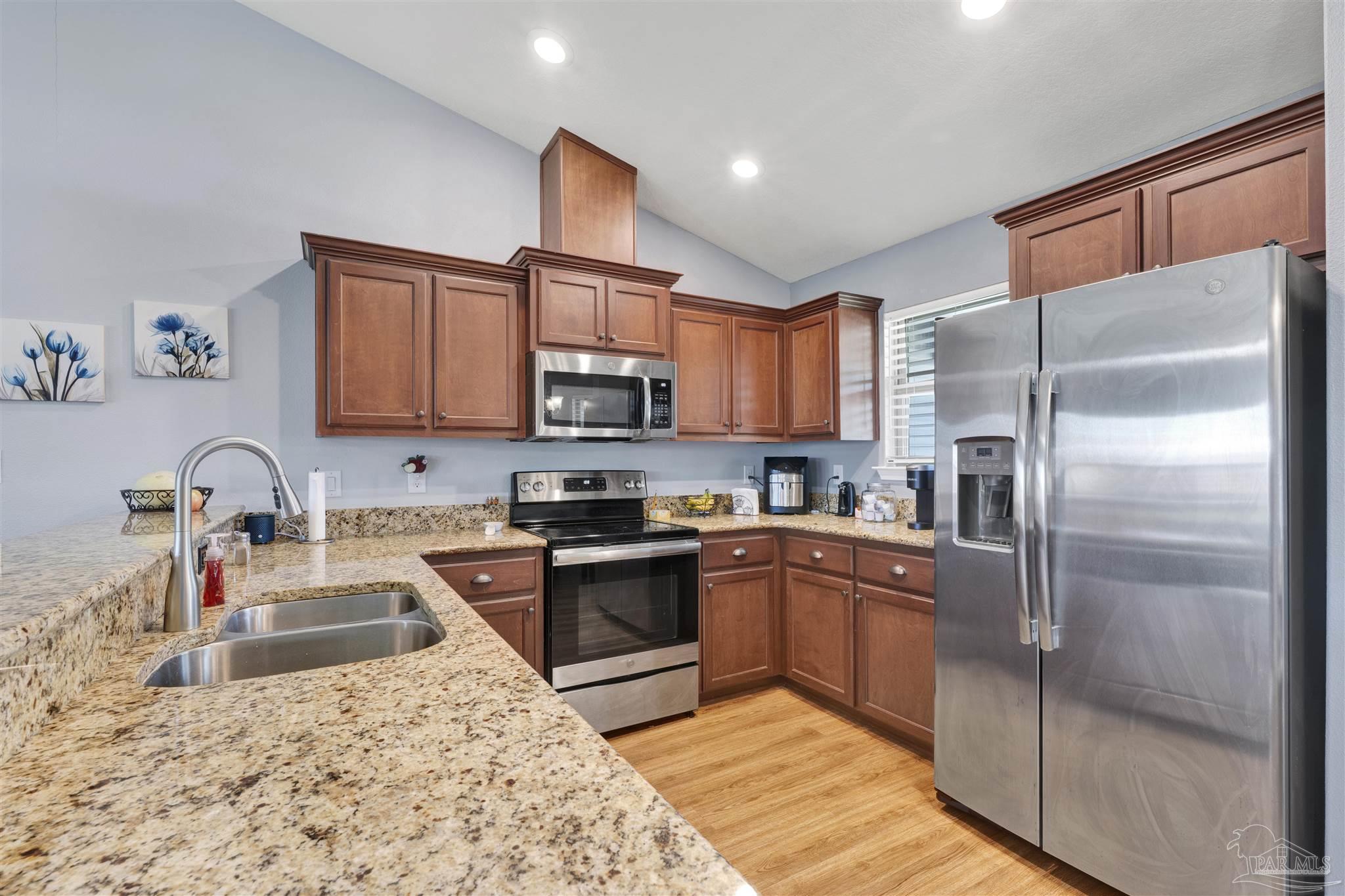 6336 Apple Ridge Circle Pensacola, FL 32526 - Photo 10 of 41 a kitchen with stainless steel appliances granite countertop a refrigerator sink and cabinets
