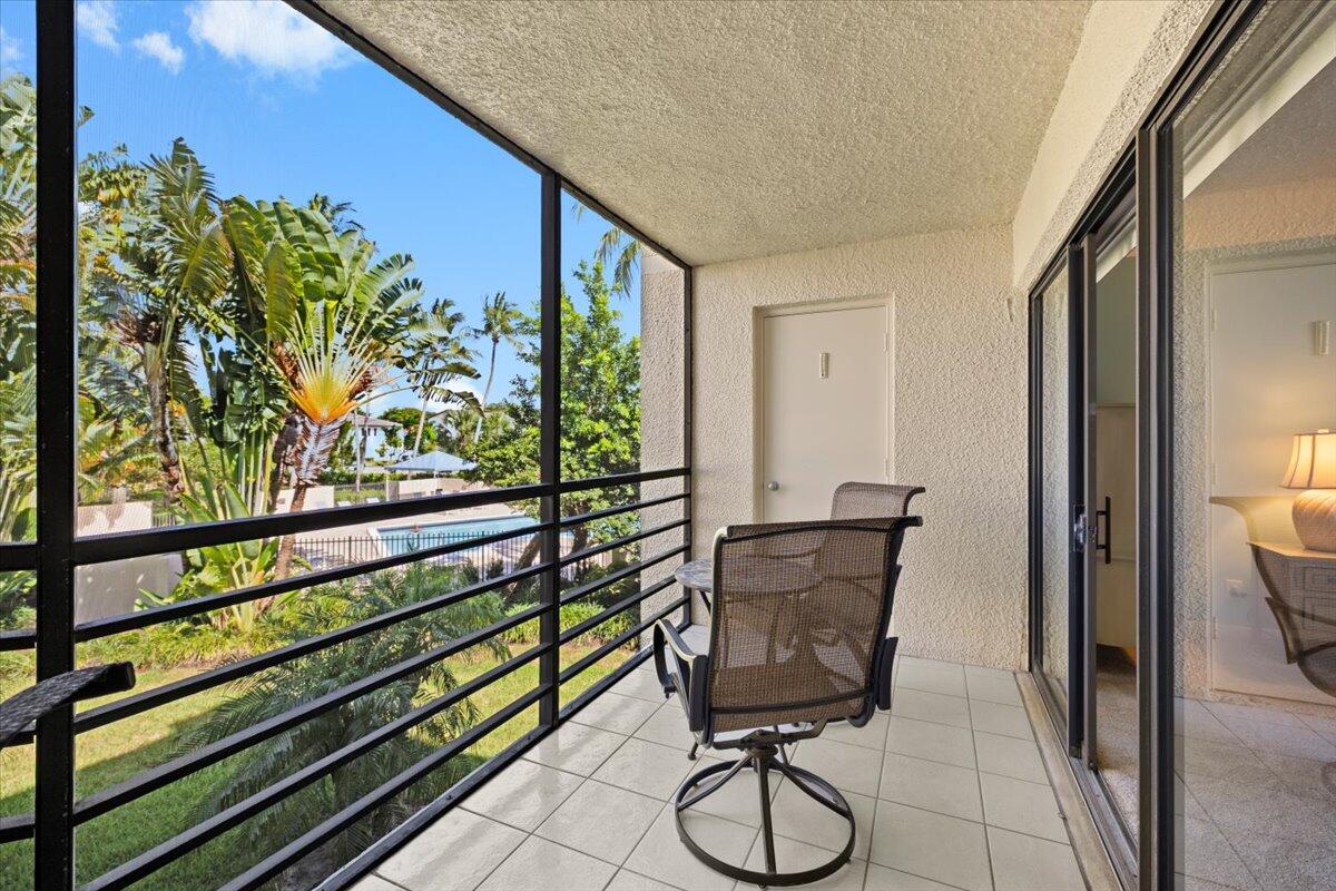 5851 Camino Del Sol, Unit 203 Boca Raton, FL 33433 - Photo 11 of 33 PATIO OVERLOOKING 1 OF 4 COMM. POOLS