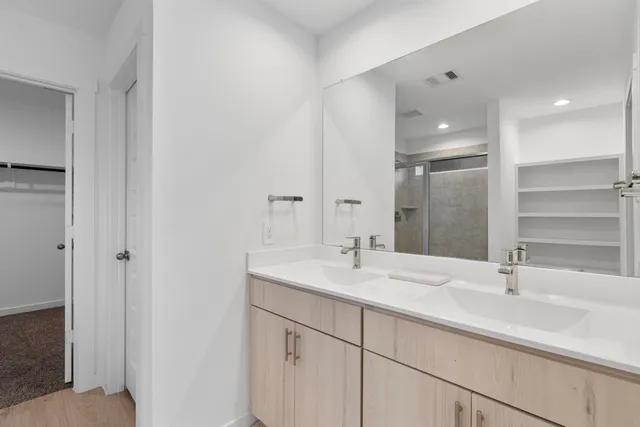 a bathroom with a sink double vanity and a mirror