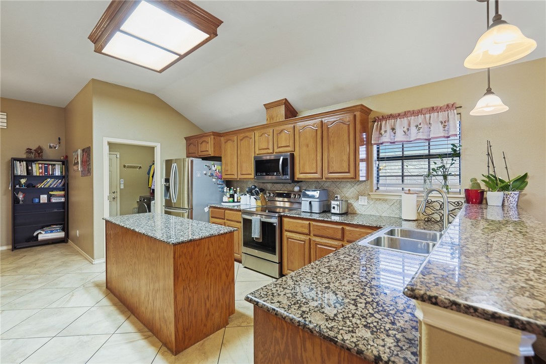 314 Hancock Odem, TX 78370 - Photo 12 of 30 a kitchen with stainless steel appliances granite countertop a stove oven and a sink