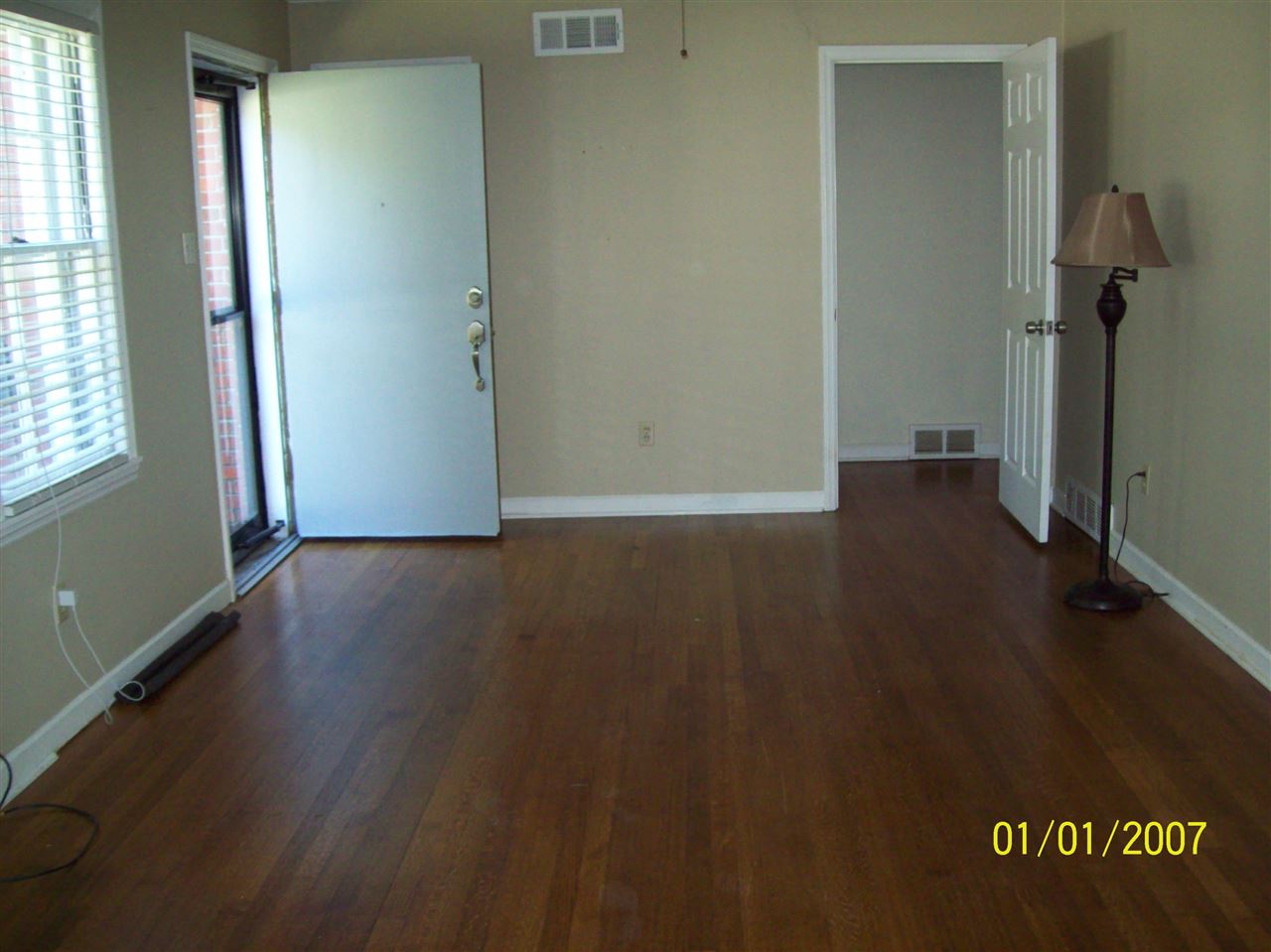 1663 Welsh Road Memphis, TN 38117 - Photo 2 of 12 an empty room with wooden floor and windows