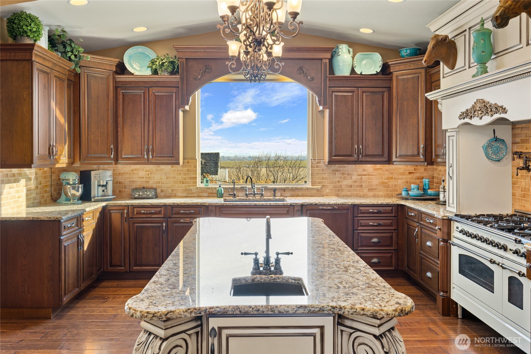 1800 Strande Road Ellensburg, WA 98926 - Photo 16 of 40 a kitchen with stainless steel appliances granite countertop a stove a sink dishwasher and cabinets with wooden floor