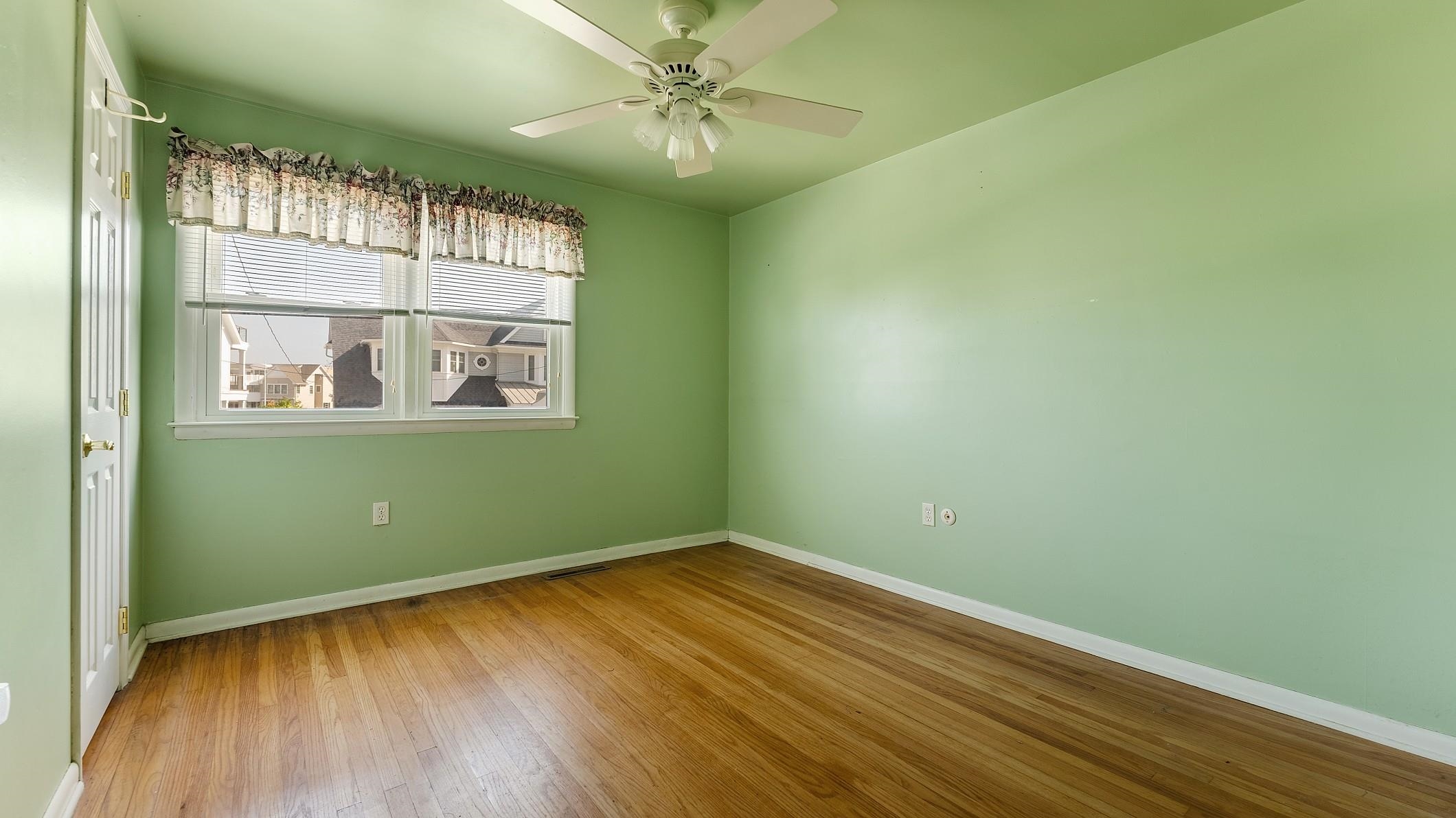 74 Walnut Road Ocean City, NJ 08226 - Photo 17 of 35 an empty room with wooden floor and windows
