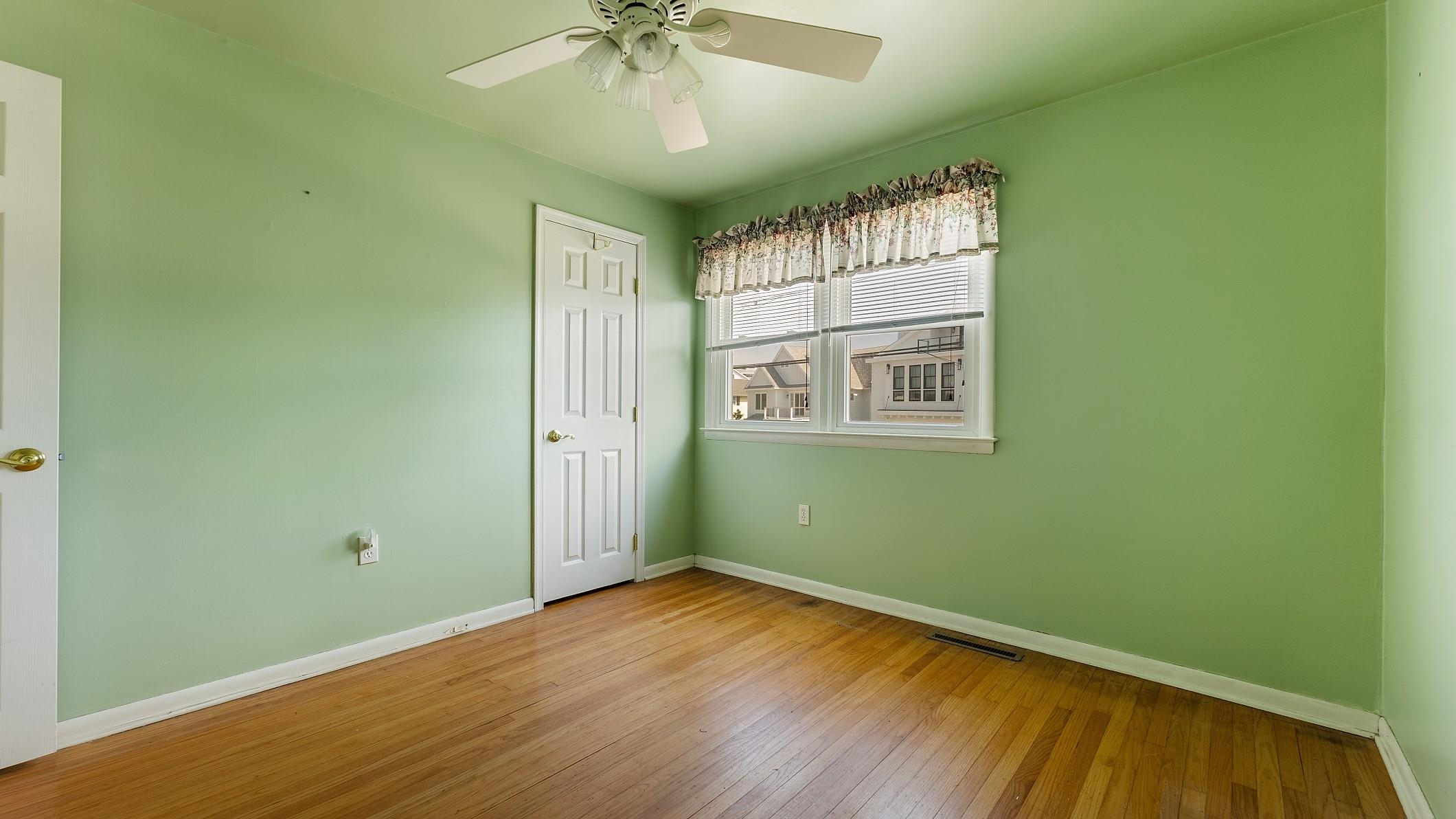 74 Walnut Road Ocean City, NJ 08226 - Photo 18 of 35 an empty room with wooden floor and windows
