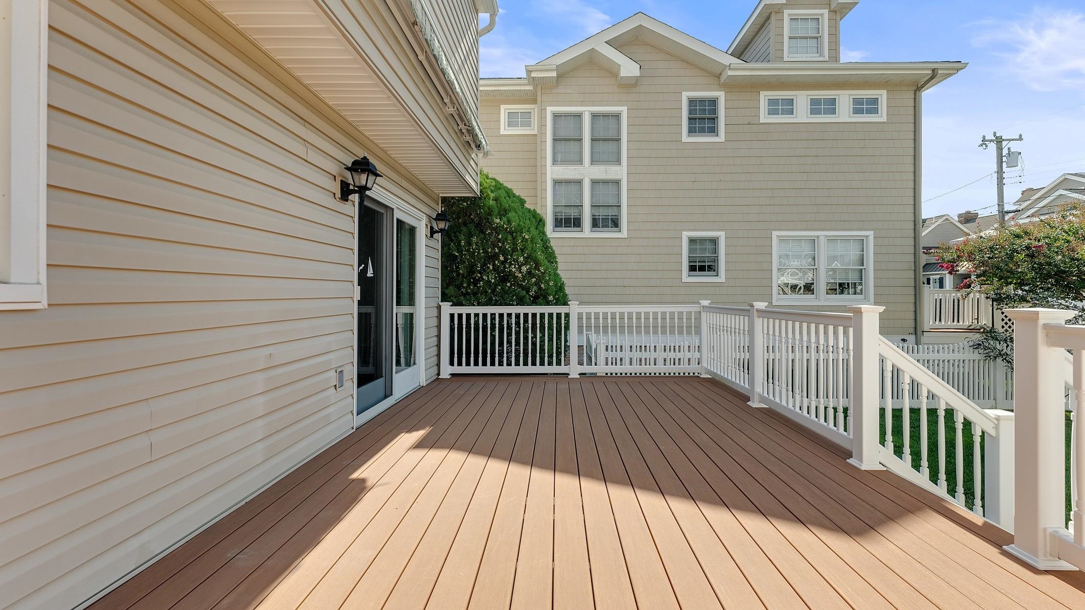 74 Walnut Road Ocean City, NJ 08226 - Photo 22 of 35 a view of a wooden deck with a yard