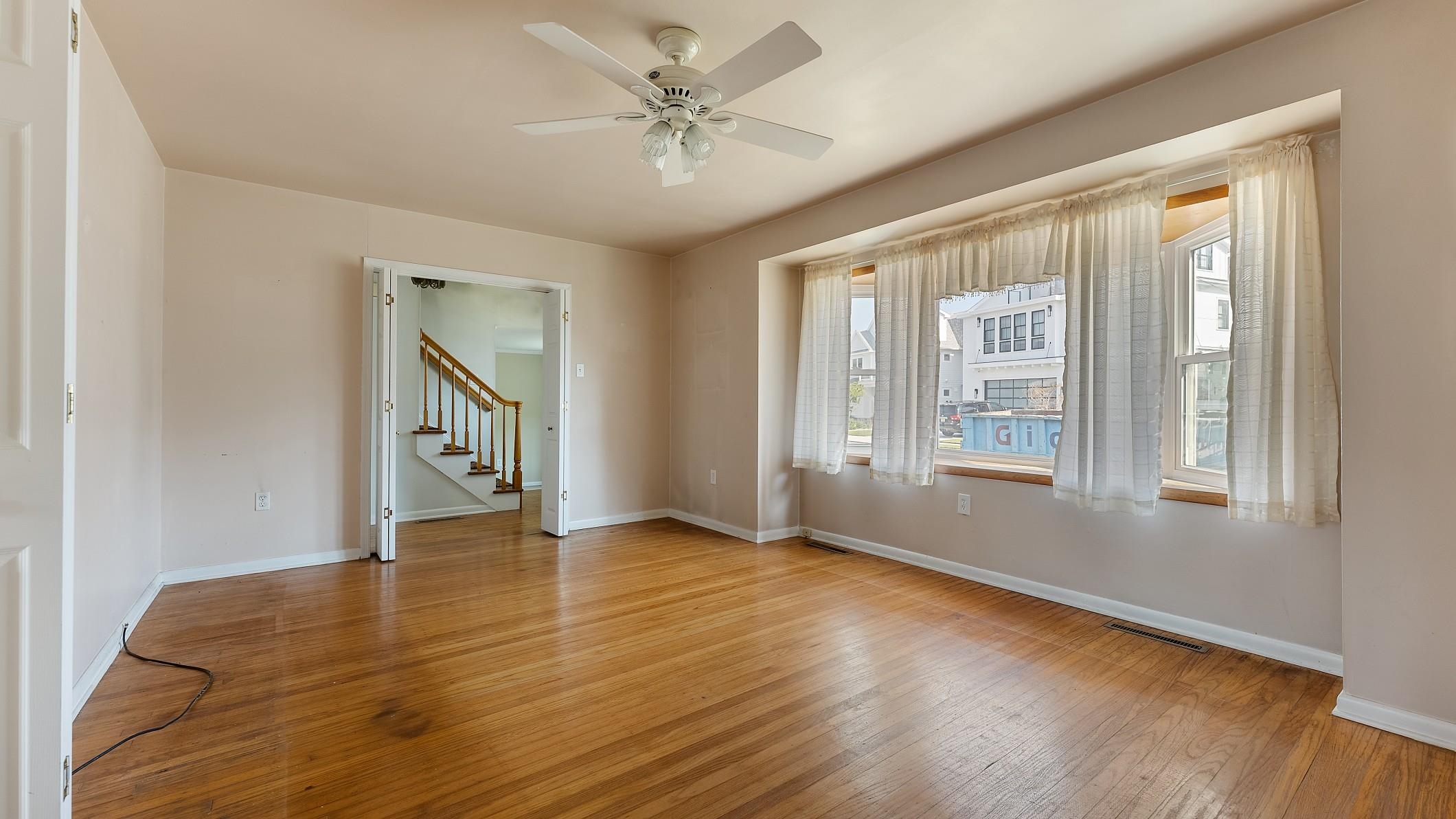 74 Walnut Road Ocean City, NJ 08226 - Photo 4 of 35 a view of an empty room with window and wooden floor