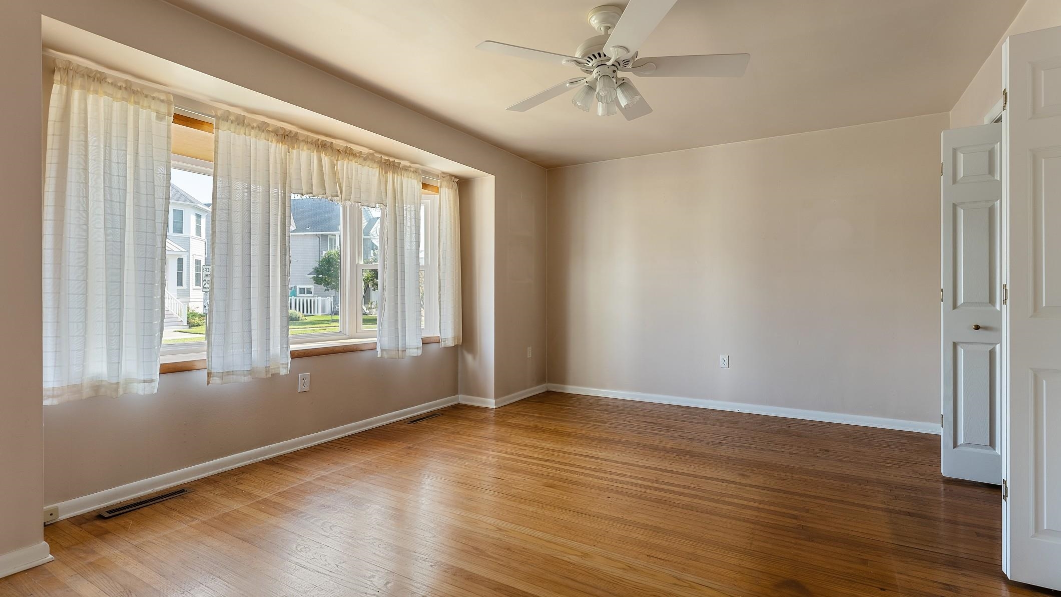 74 Walnut Road Ocean City, NJ 08226 - Photo 5 of 35 a view of an empty room with wooden floor and a window