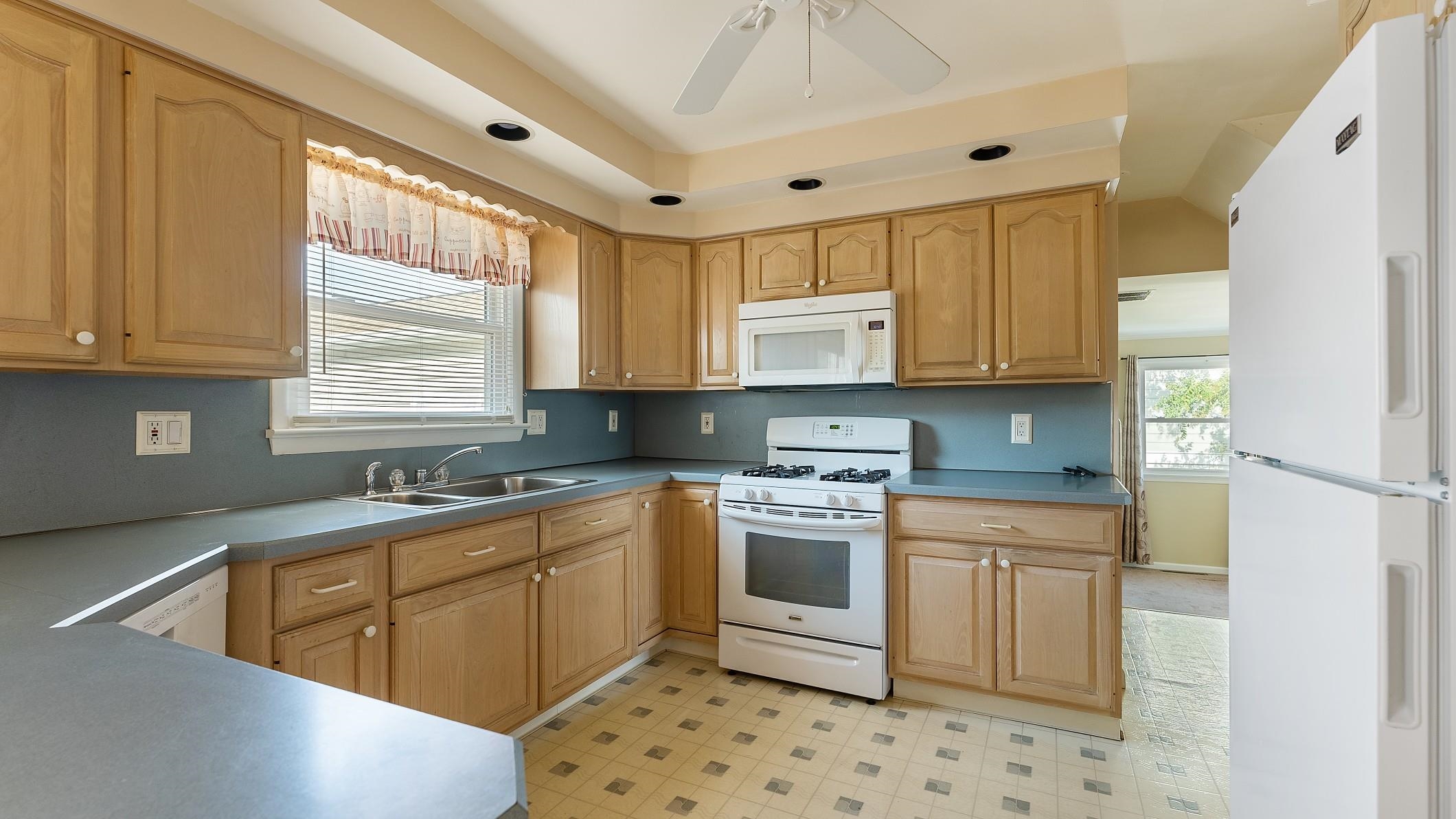 74 Walnut Road Ocean City, NJ 08226 - Photo 7 of 35 a kitchen with stainless steel appliances granite countertop a sink a stove a refrigerator a microwave a sink and cabinets