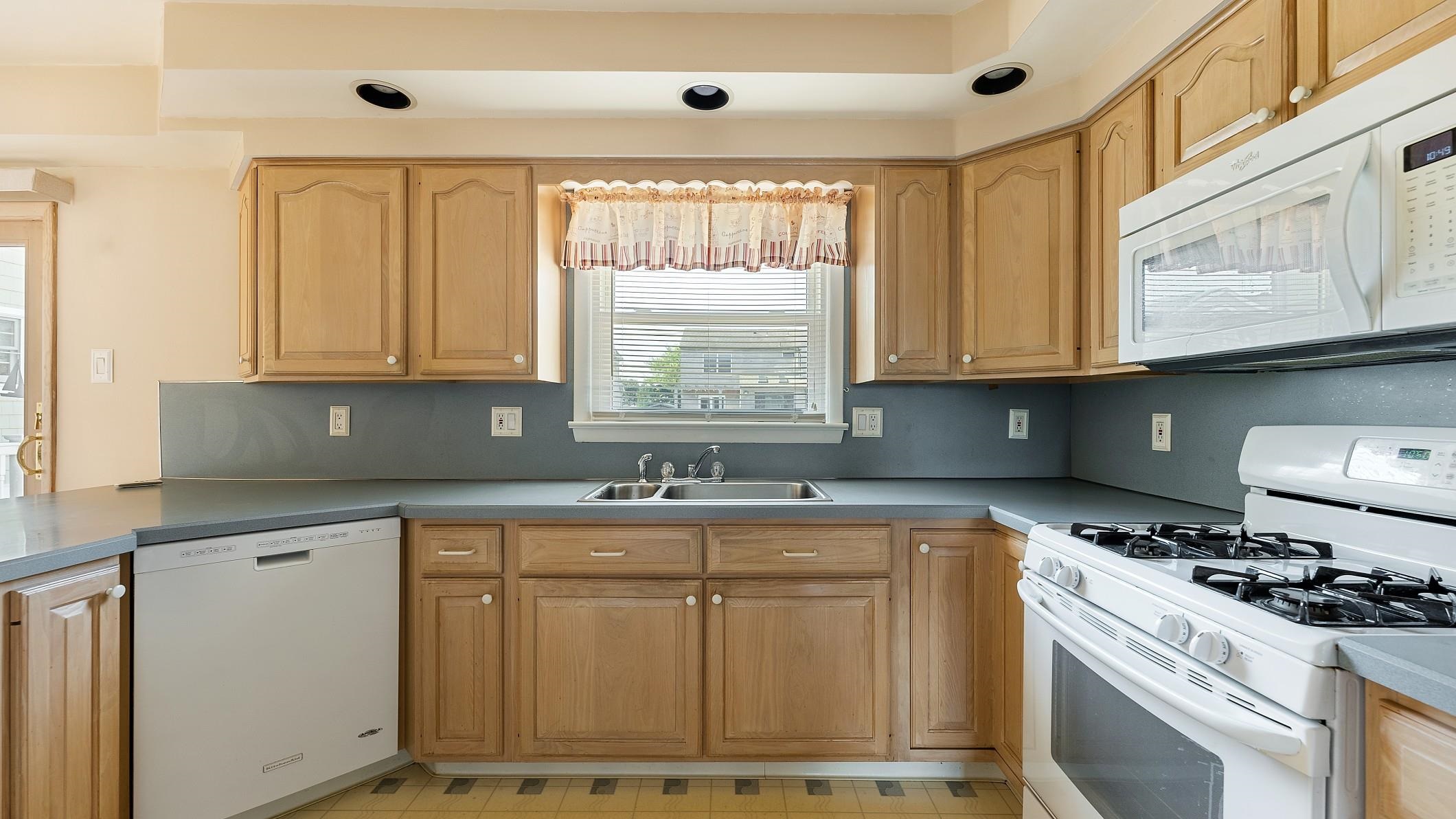 74 Walnut Road Ocean City, NJ 08226 - Photo 8 of 35 a kitchen with granite countertop cabinets stainless steel appliances a sink and a window