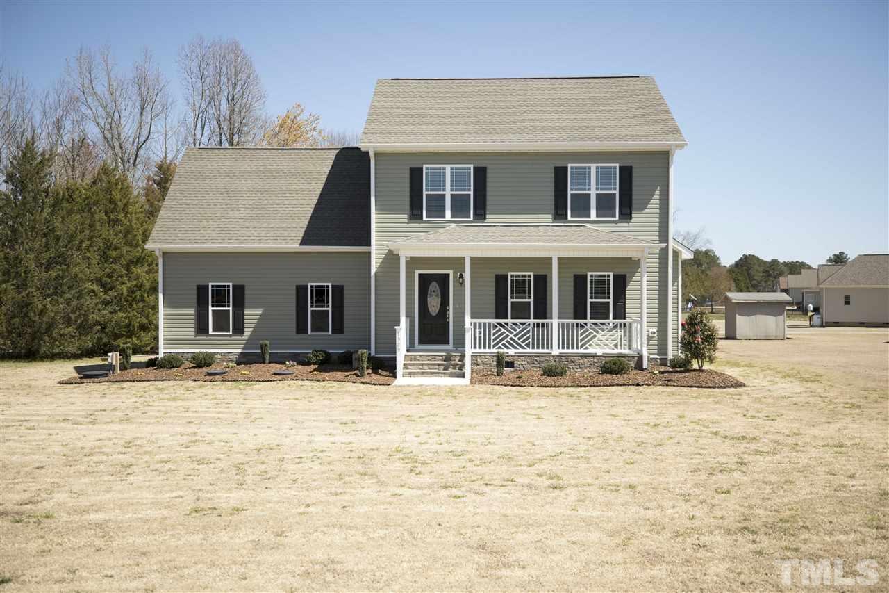 1309 Silver Farm Road Raleigh, NC 27603 - Photo 1 of 24 a front view of a house with a yard