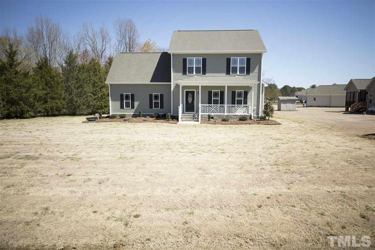 1309 Silver Farm Road Raleigh, NC 27603 - Photo 2 of 24 a front view of a house with a yard