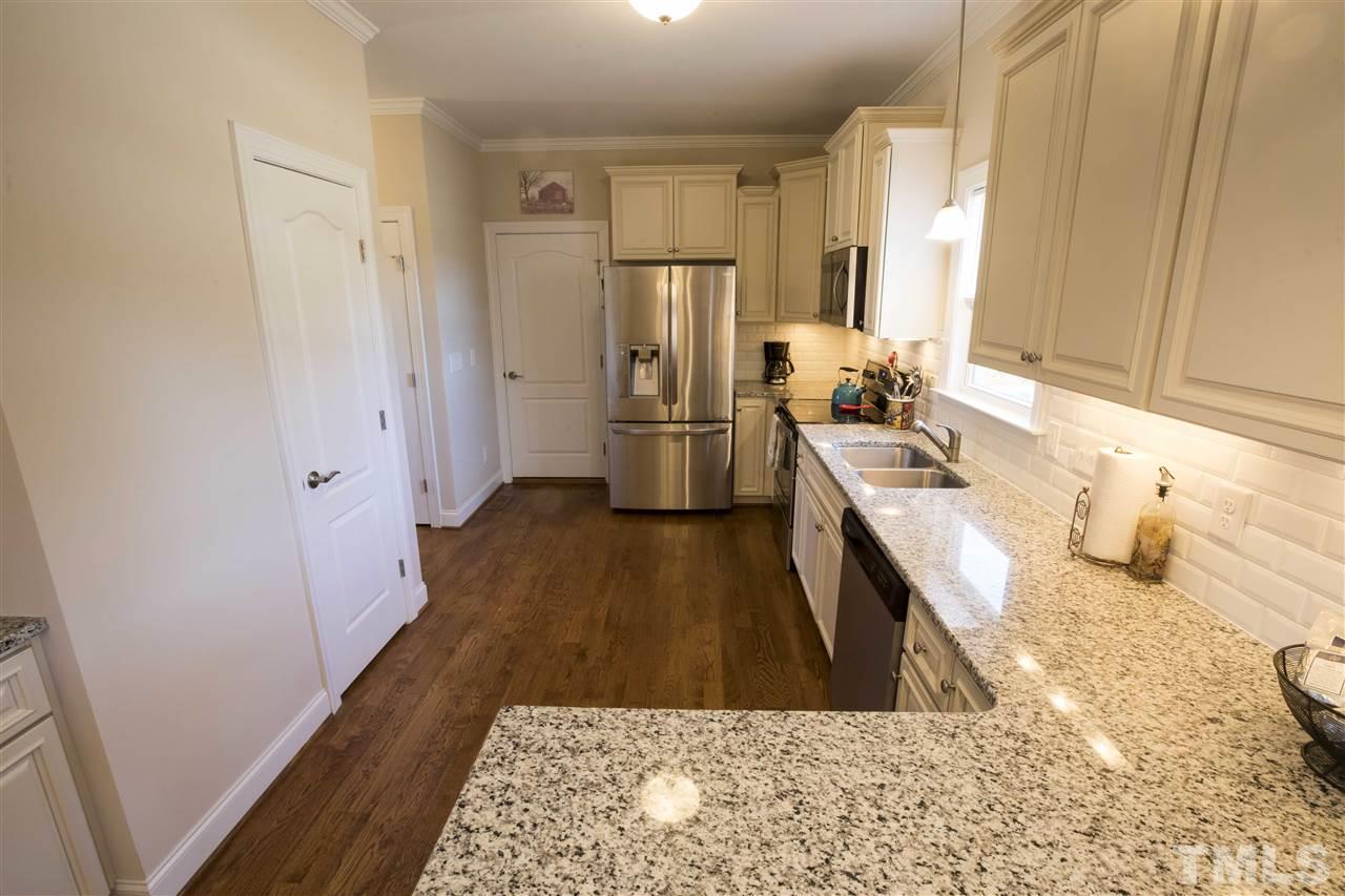 1309 Silver Farm Road Raleigh, NC 27603 - Photo 11 of 24 a kitchen with a sink stove and refrigerator