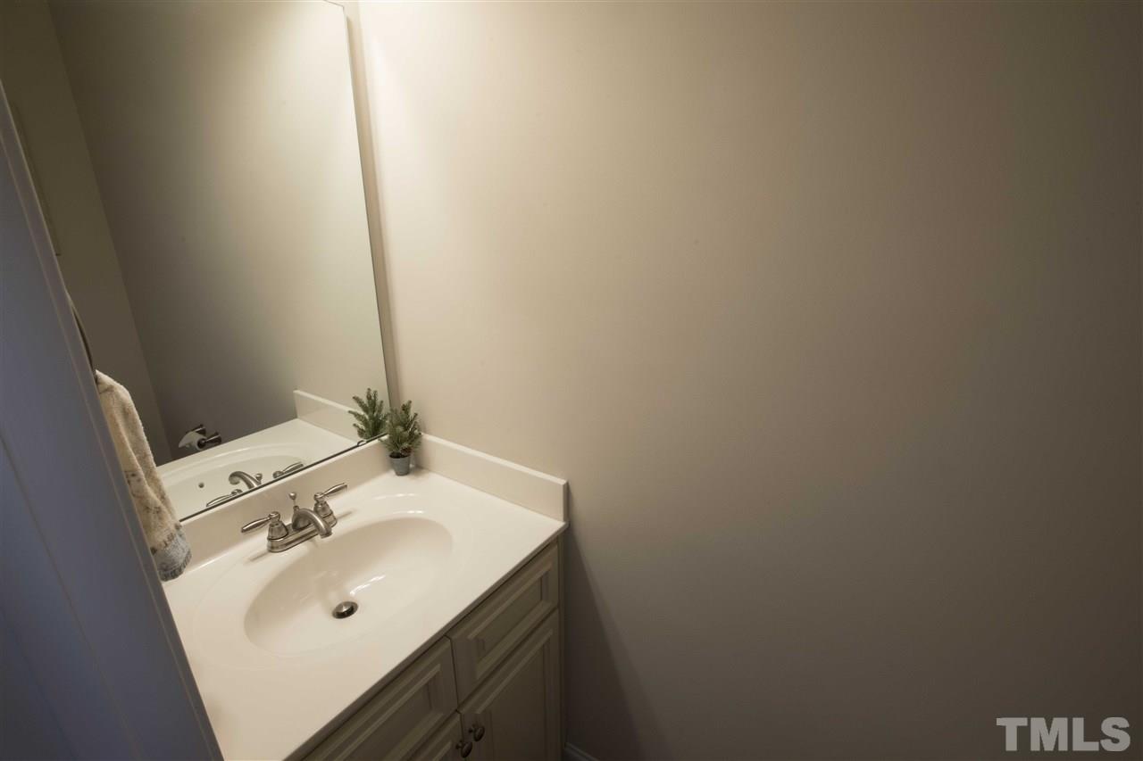 1309 Silver Farm Road Raleigh, NC 27603 - Photo 12 of 24 a bathroom with a sink and a mirror