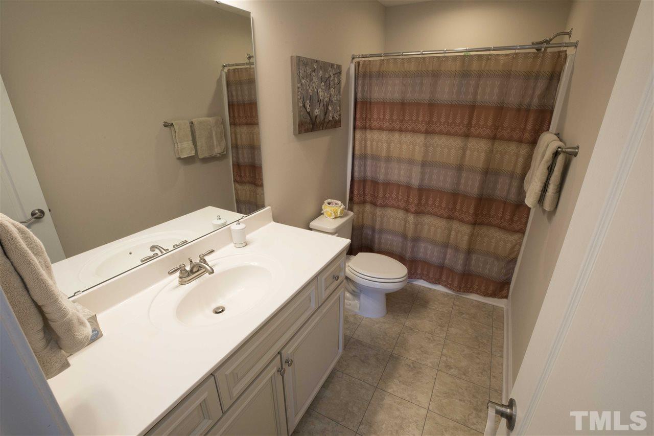 1309 Silver Farm Road Raleigh, NC 27603 - Photo 14 of 24 a bathroom with a sink a toilet and shower