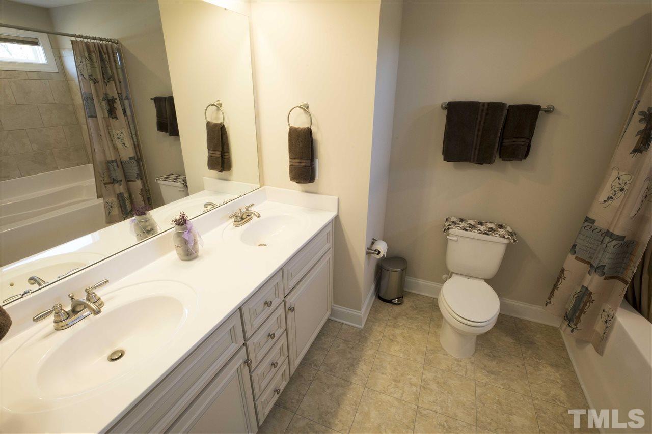 1309 Silver Farm Road Raleigh, NC 27603 - Photo 16 of 24 a bathroom with a sink toilet and shower