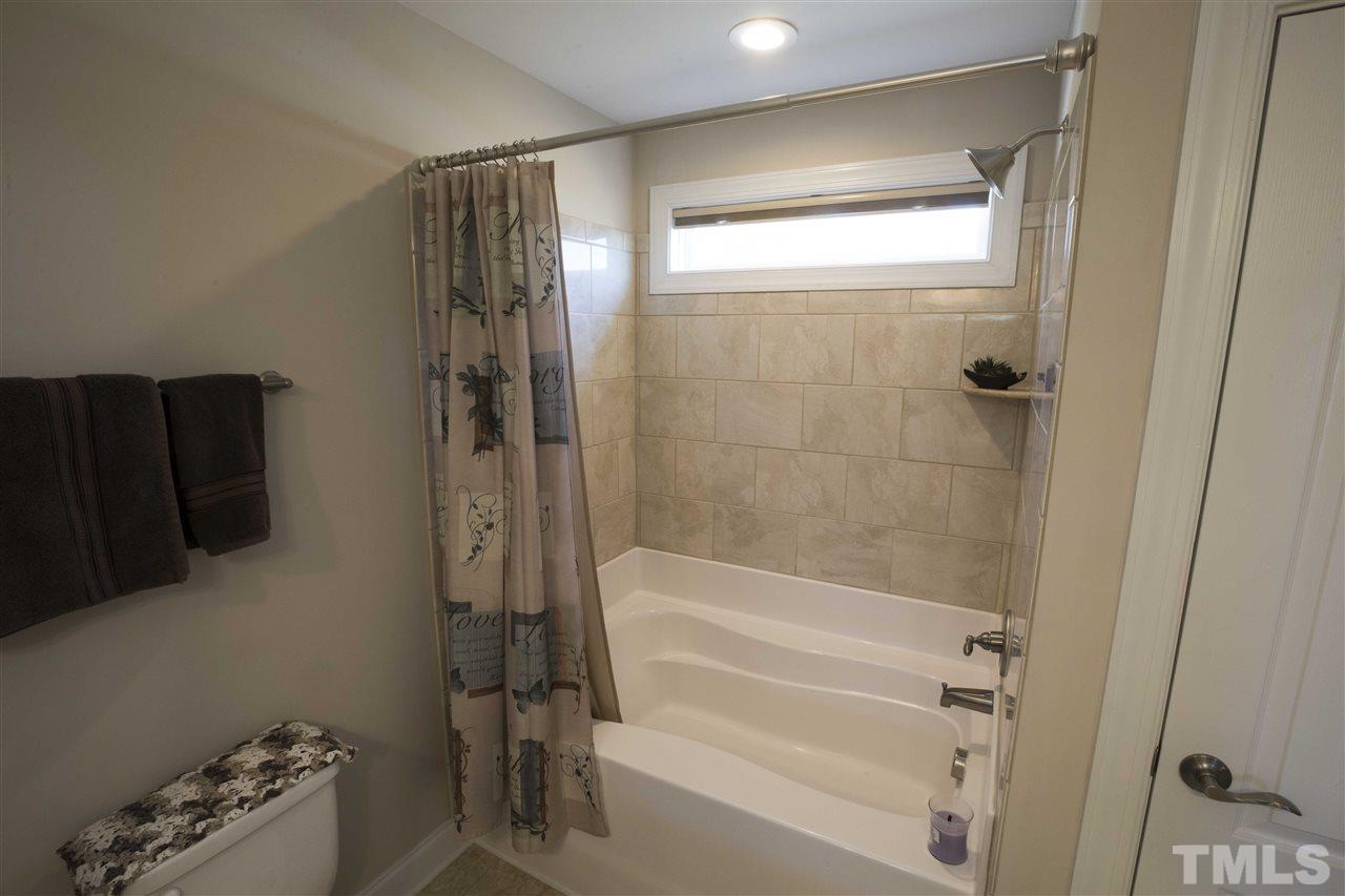 1309 Silver Farm Road Raleigh, NC 27603 - Photo 17 of 24 a bathroom with a bathtub